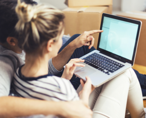 couple doing research on laptop