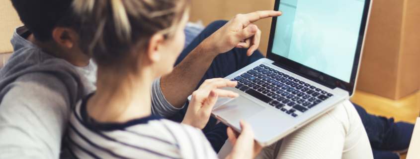 couple doing research on laptop