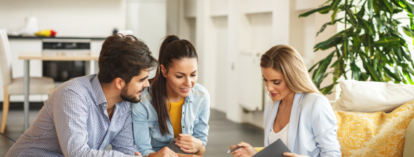 Female Real Estate agent with a couple